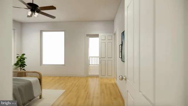 a bedroom with a bed and painting on the wall