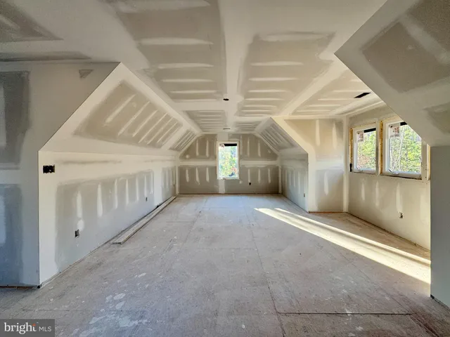 a view of a hallway with wooden floor and entryway