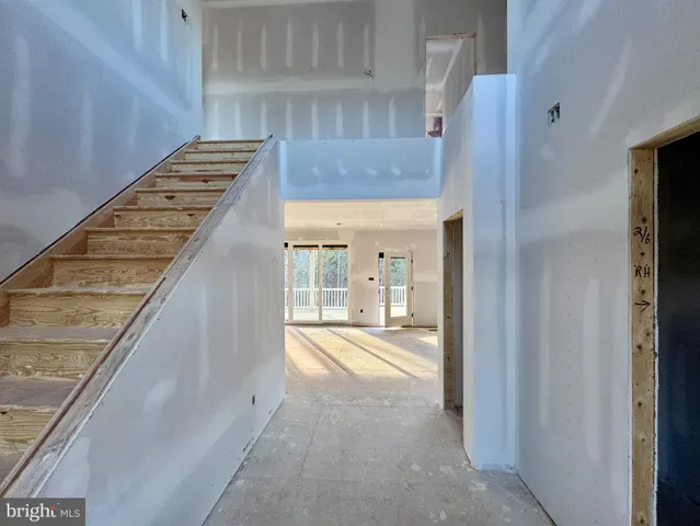 a view of an empty room with a fireplace and a window