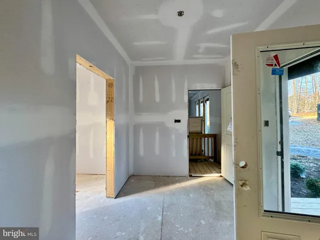 a spacious bedroom with a large bed and a large window