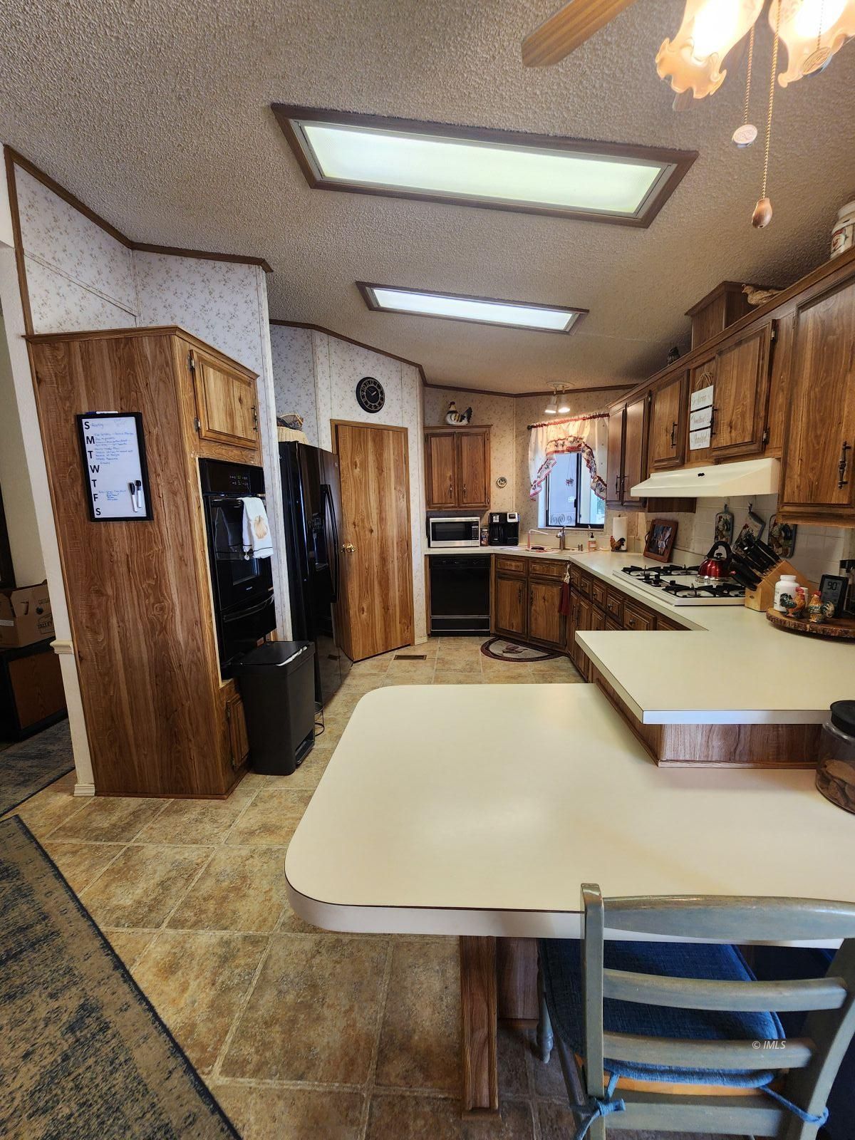 340 South Washington Street Independence, CA 93526 - Photo 12 of 18 a kitchen with stainless steel appliances granite countertop a refrigerator a sink a stove and a refrigerator