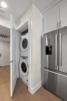301 Border Street, Unit 406 Boston, MA 02128 - Photo 12 of 21 a view of a kitchen with refrigerator and washer