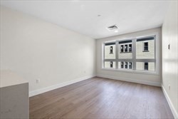 301 Border Street, Unit 406 Boston, MA 02128 - Photo 6 of 21 a view of a room with wooden floor and a window