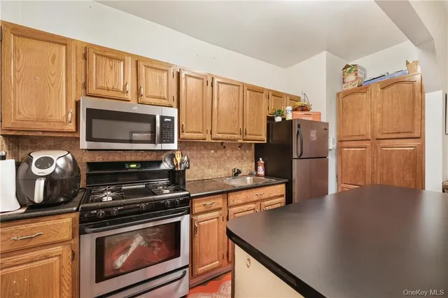a kitchen with a refrigerator stove and microwave