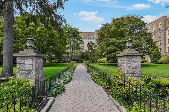 a view of a pathway with a garden