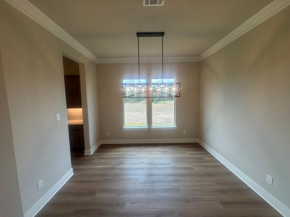 412 Indian Crk Road Van Alstyne, TX 75495 - Photo 7 of 24 a view of empty room with wooden floor and fan
