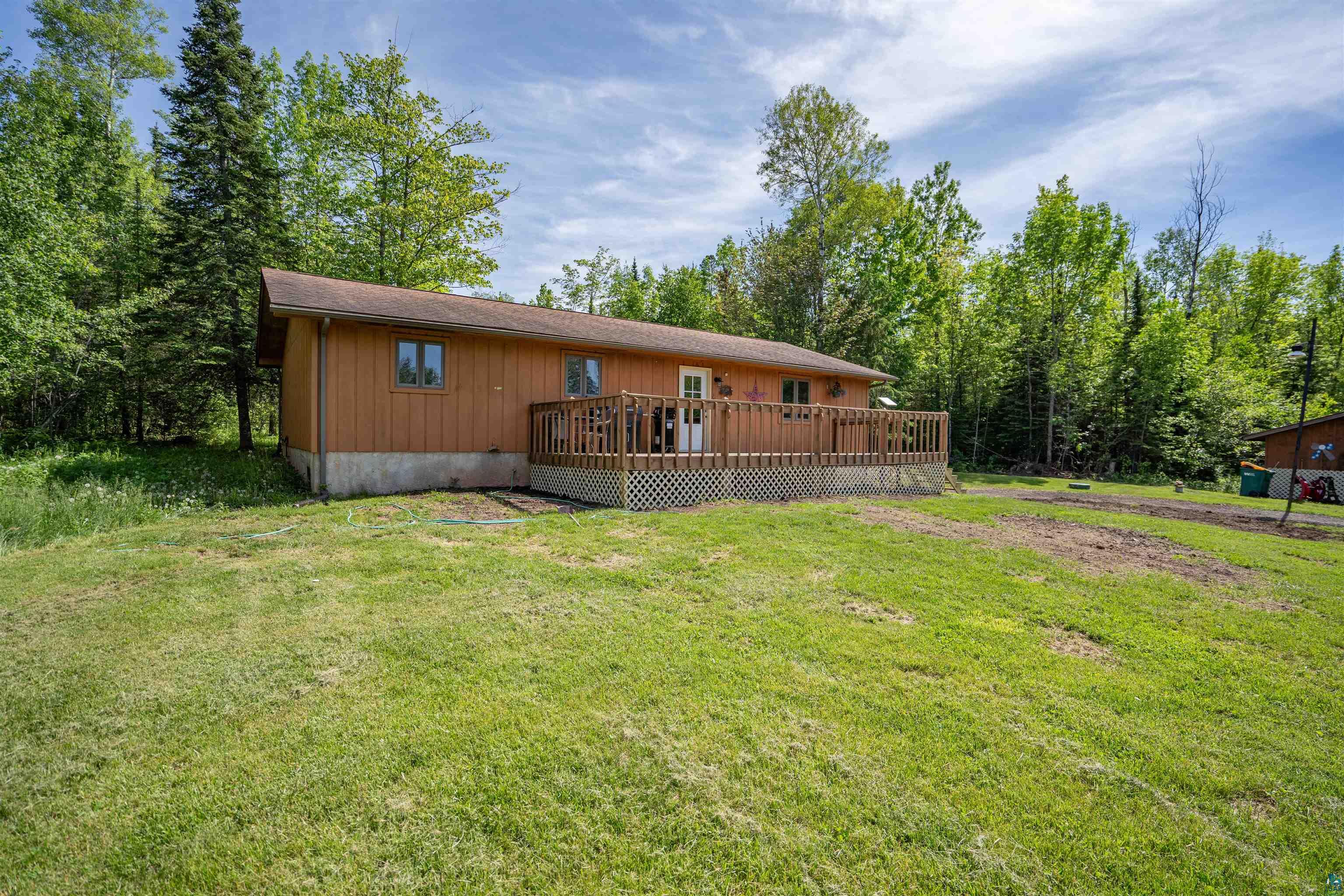9076 East Moonshine Road South Range, WI 54874 - Photo 1 of 26 Front of property featuring a deck and a lawn