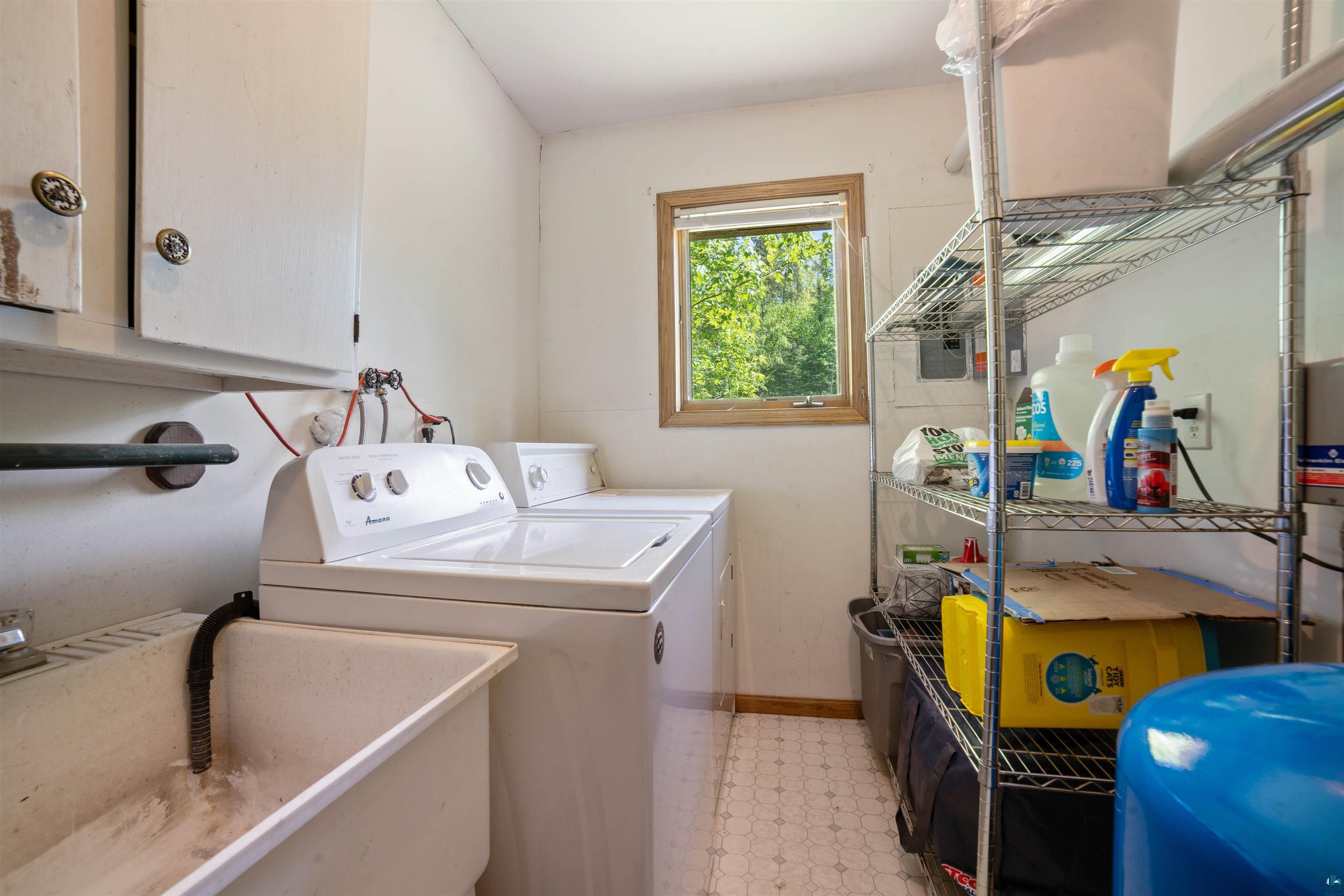 9076 East Moonshine Road South Range, WI 54874 - Photo 13 of 26 Clothes washing area featuring sink, washer and clothes dryer, and light tile flooring