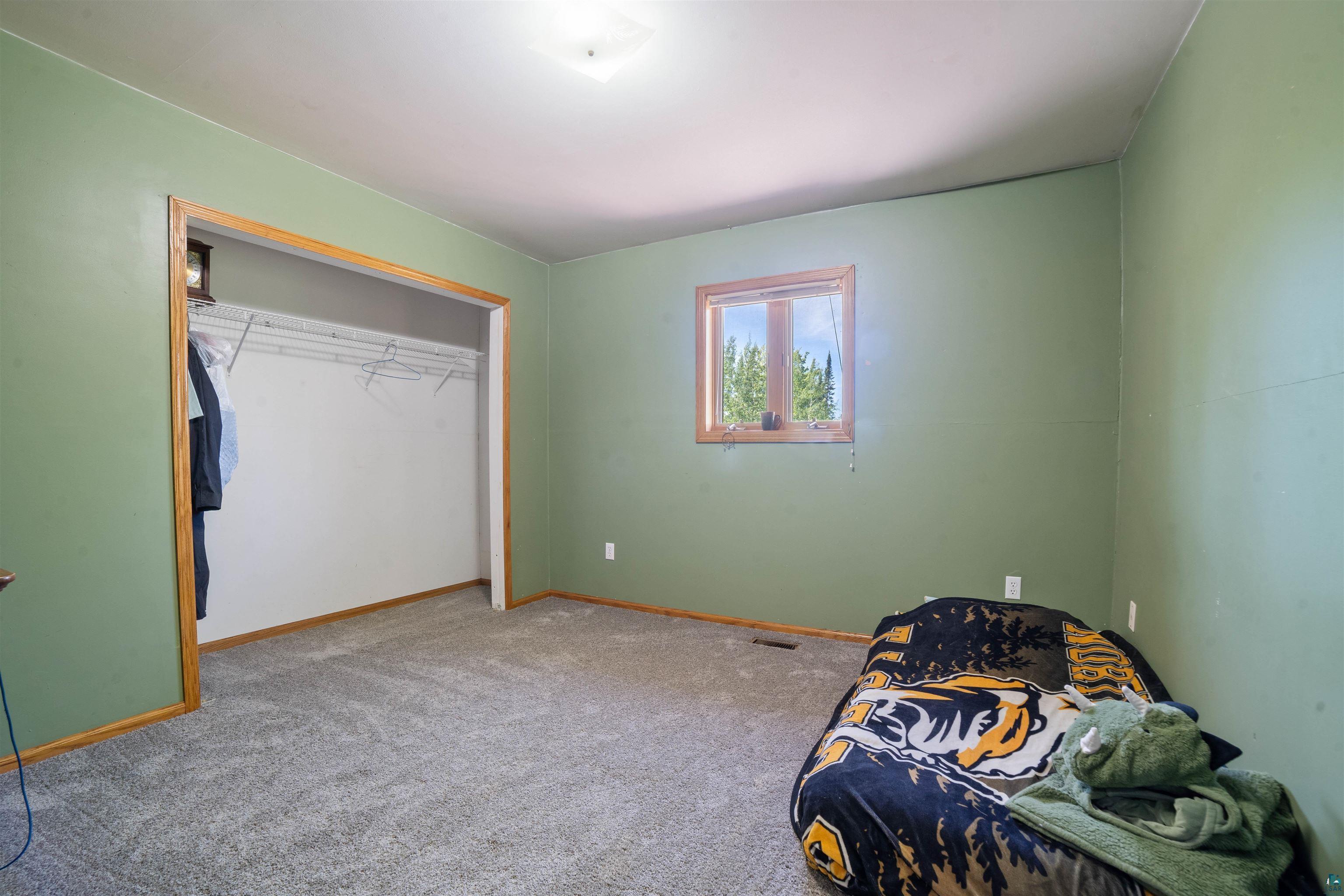 9076 East Moonshine Road South Range, WI 54874 - Photo 17 of 26 Unfurnished bedroom featuring carpet flooring and a closet