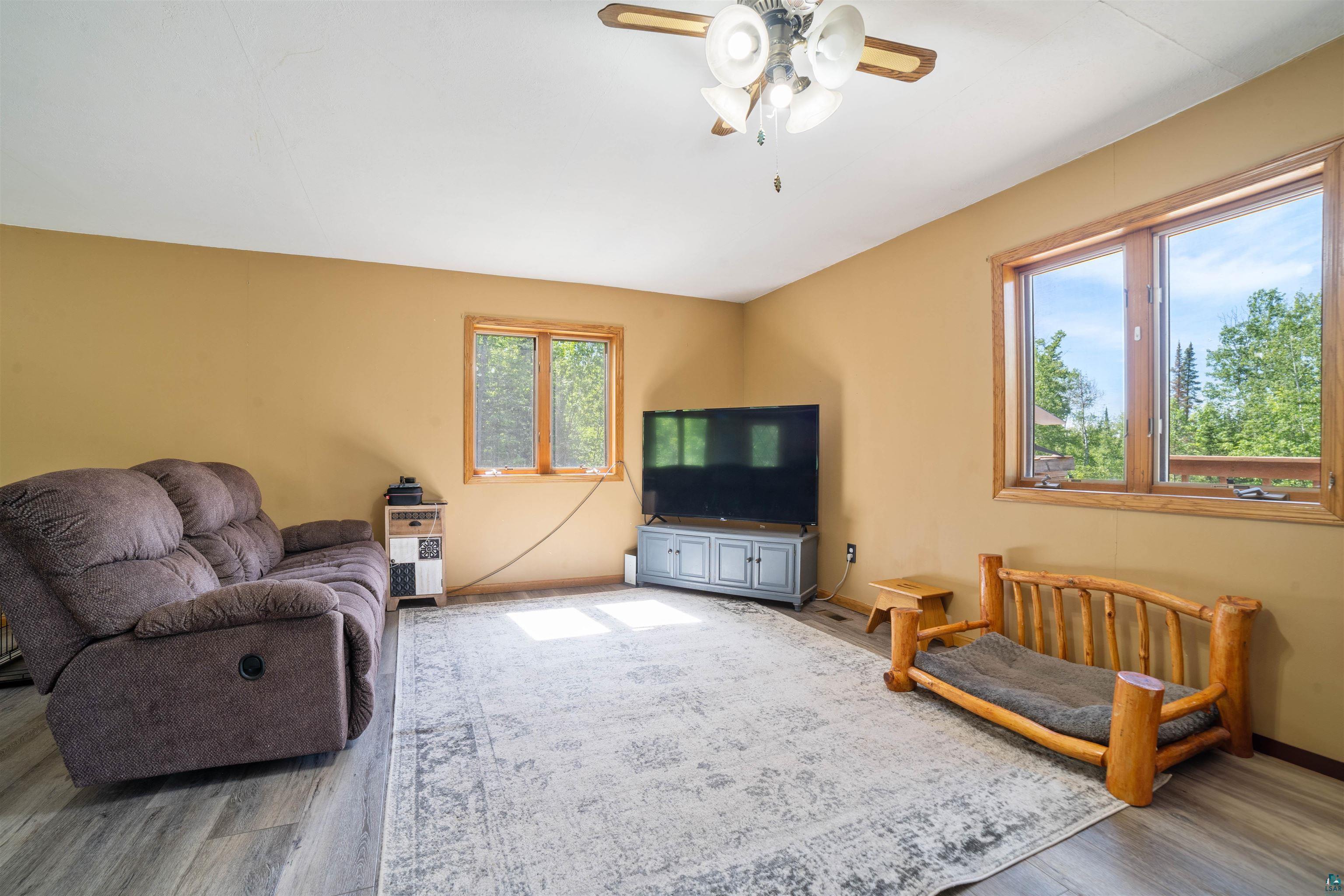 9076 East Moonshine Road South Range, WI 54874 - Photo 7 of 26 Living room with a wealth of natural light, hardwood / wood-style flooring, and ceiling fan
