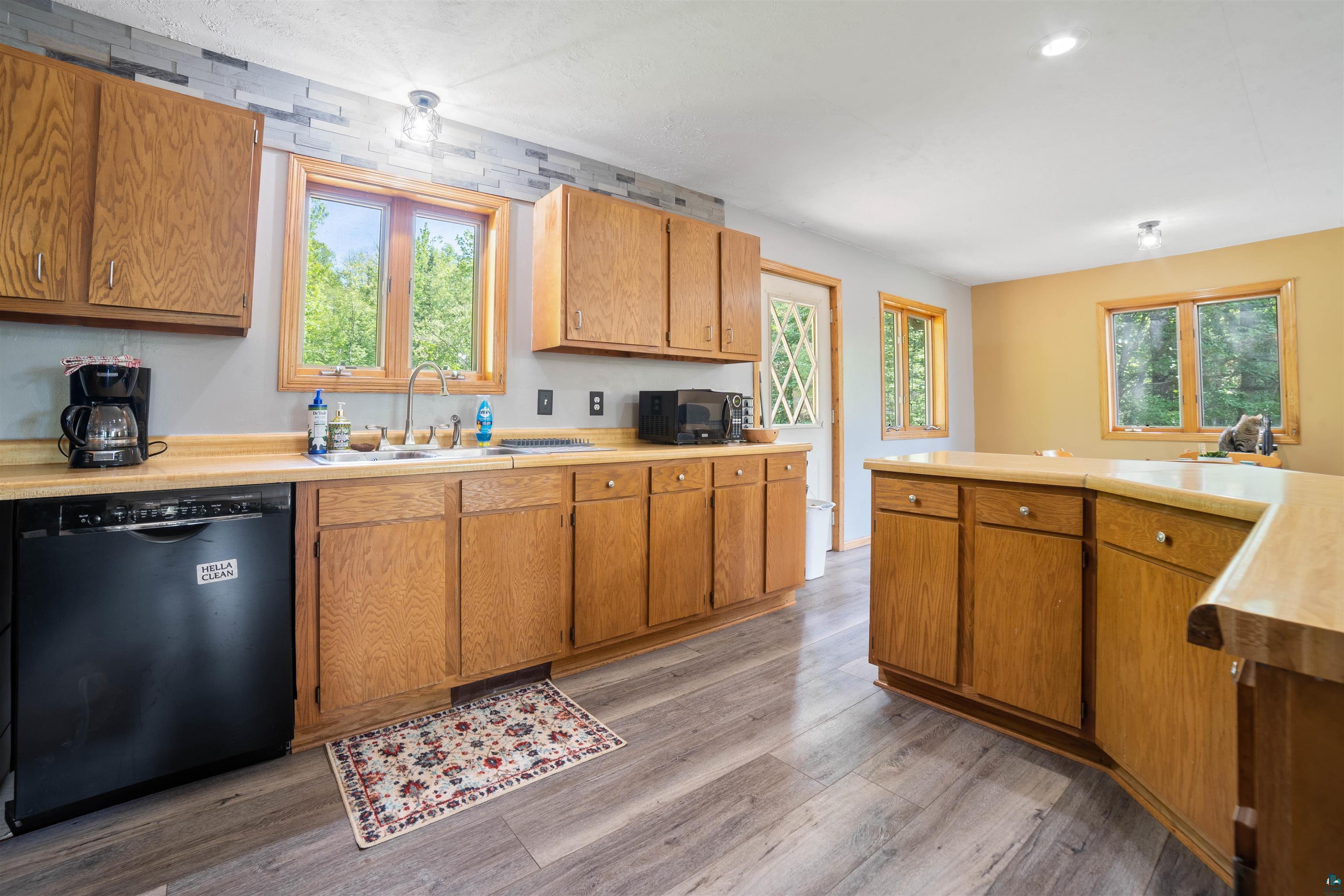 9076 East Moonshine Road South Range, WI 54874 - Photo 9 of 26 Kitchen featuring sink, black dishwasher, and wood-type flooring