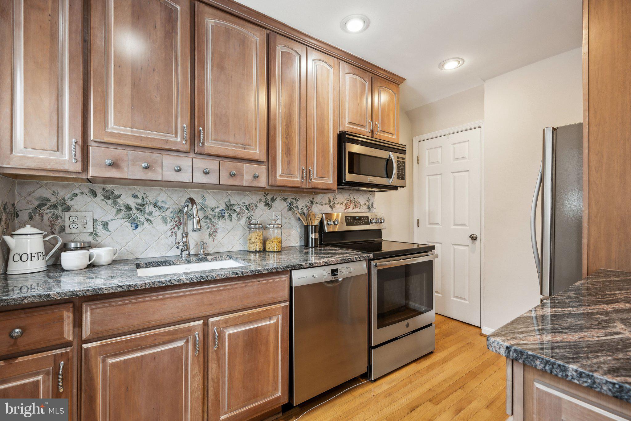 4231 32nd Road South Arlington, VA 22206 - Photo 12 of 44 a kitchen with stainless steel appliances granite countertop a stove a sink and a refrigerator