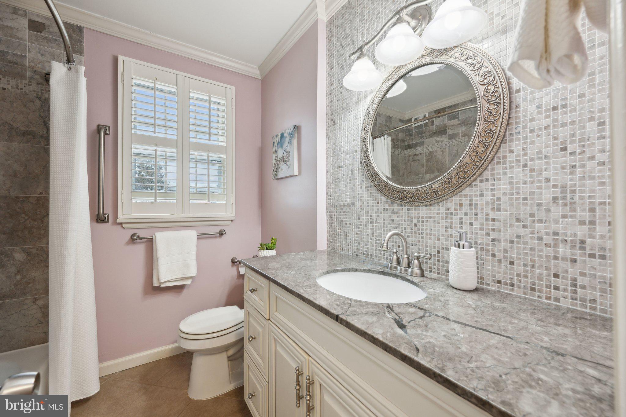 4231 32nd Road South Arlington, VA 22206 - Photo 17 of 44 a bathroom with a granite countertop toilet and a sink