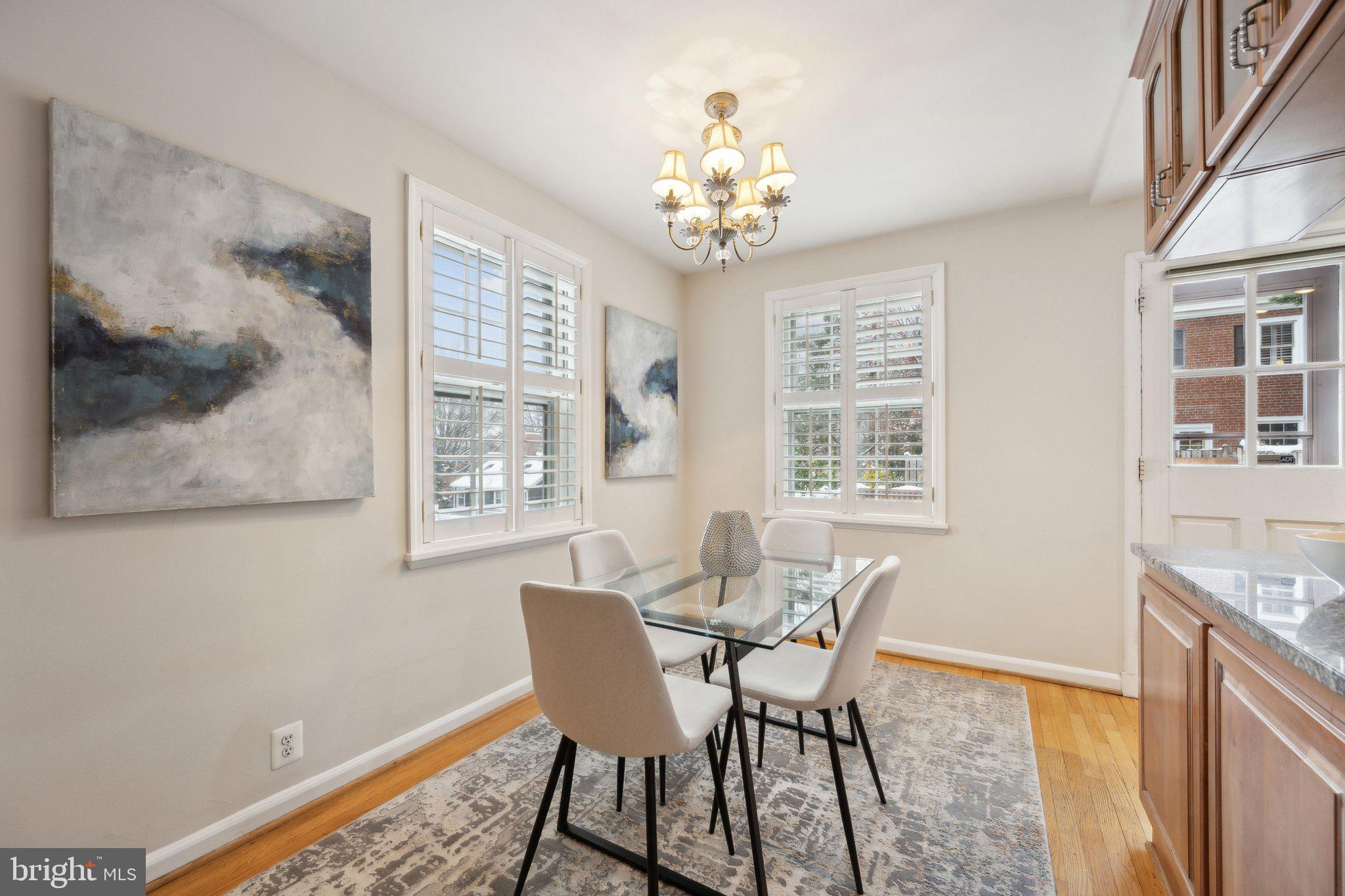 4231 32nd Road South Arlington, VA 22206 - Photo 9 of 44 a view of a dining room with furniture a chandelier and wooden floor
