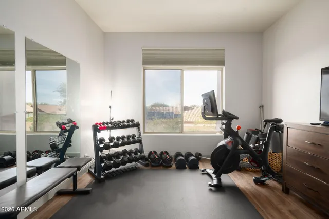 a room with gym equipment and a large window