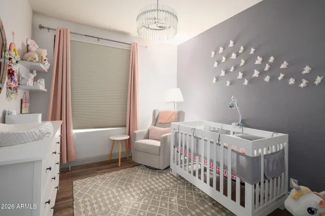 a bedroom with a bed and a chandelier