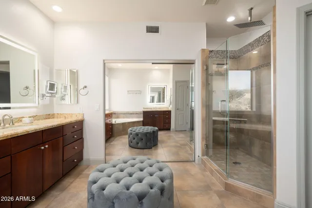 a bathroom with a shower sink and mirror