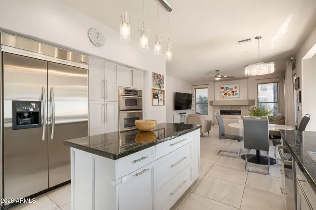 a kitchen with stainless steel appliances granite countertop a sink and refrigerator