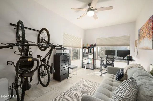 a living room with furniture a flat screen tv and a window