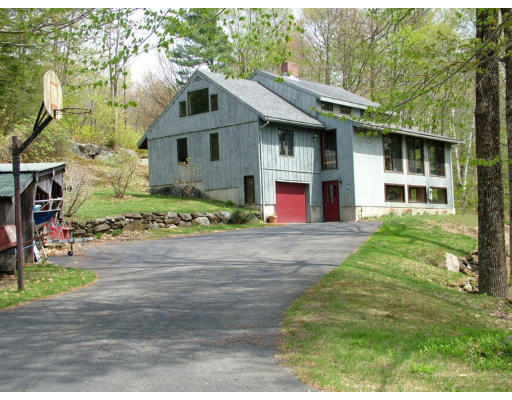 1453 W Road Ashfield, MA 01330 - Photo 1 of 12 a front view of a house with a garden