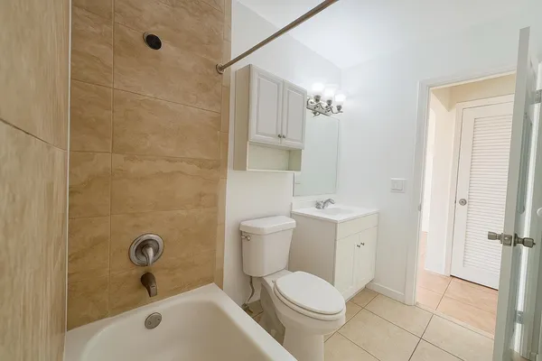a bathroom with a toilet a sink and shower