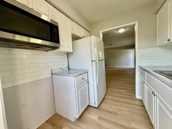 a kitchen with a refrigerator and a stove