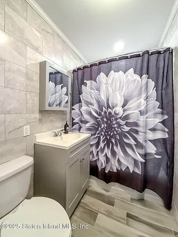 a bathroom with a sink and mirror with toilet