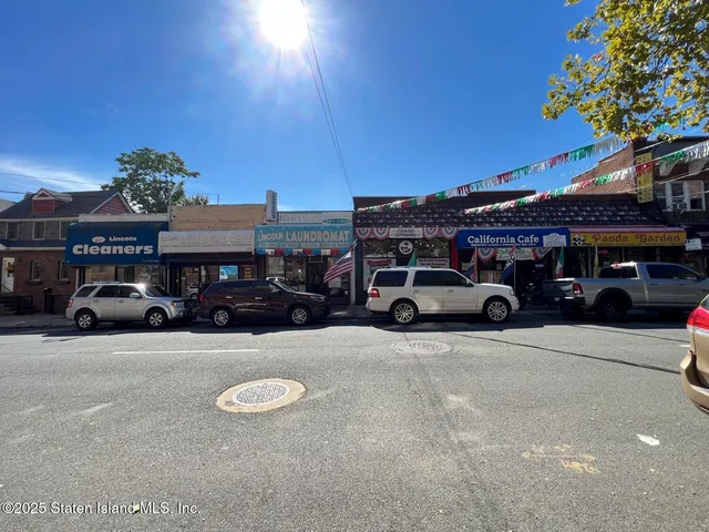 a view of a cars park in front of a building