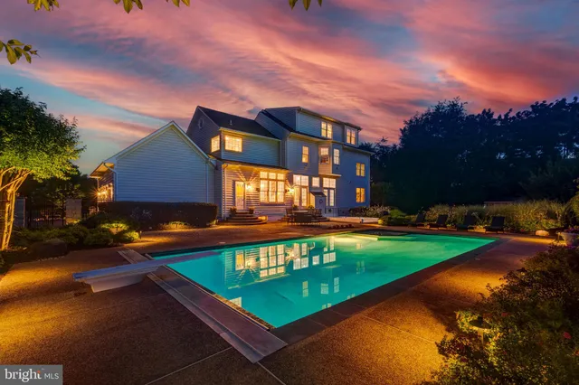 a view of a house with swimming pool yard and a yard