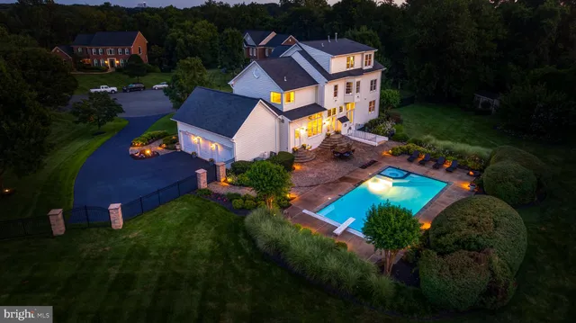 an aerial view of a house with pool garden and outdoor seating