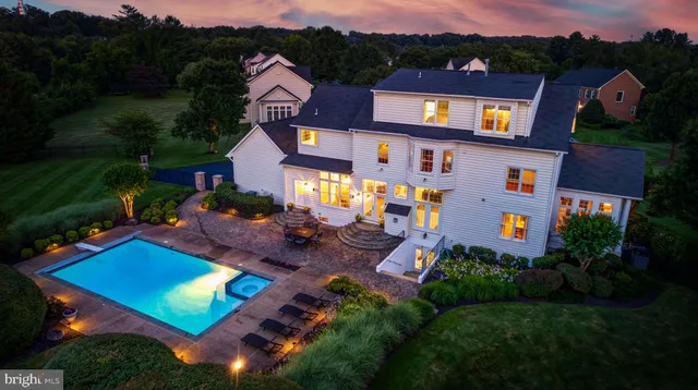 an aerial view of multiple houses with a big yard