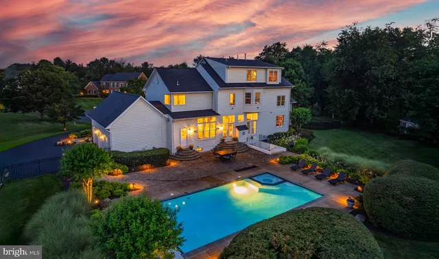 an aerial view of a house with swimming pool yard and mountain view in back