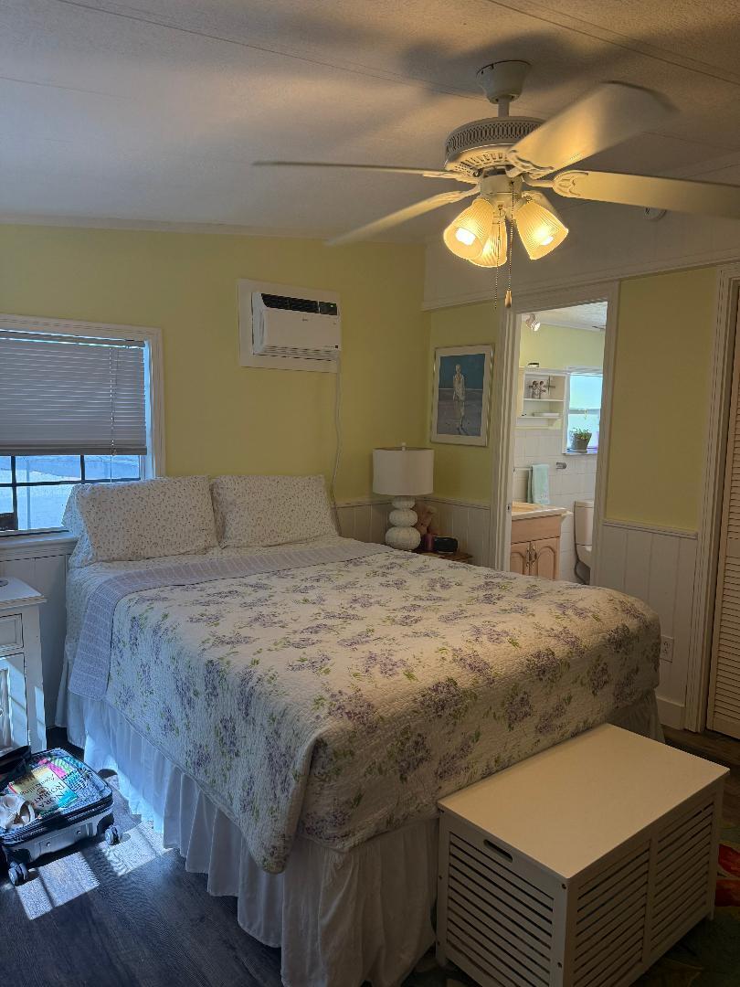 27973 Snapper Lane Summerland Key, FL 33042 - Photo 23 of 25 a bedroom with a bed and a chandelier