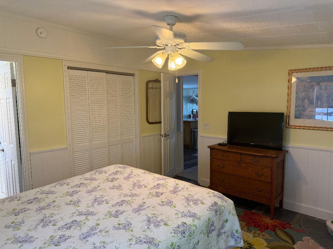 27973 Snapper Lane Summerland Key, FL 33042 - Photo 25 of 25 a bedroom with a bed and a flat screen tv