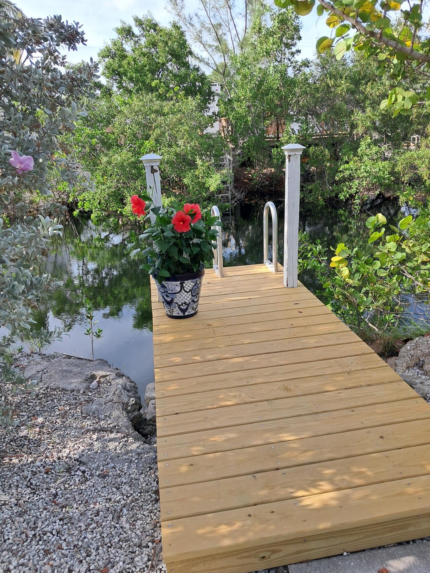 27973 Snapper Lane Summerland Key, FL 33042 - Photo 6 of 25 a white bench sitting in front of a house