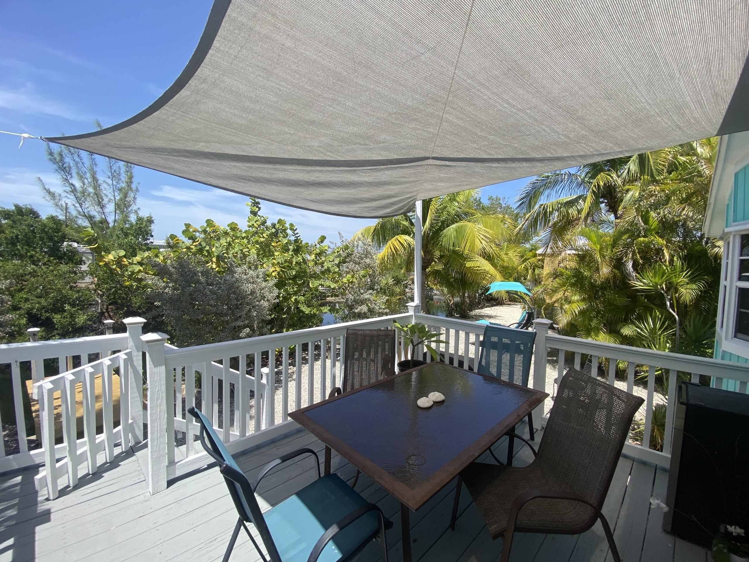 27973 Snapper Lane Summerland Key, FL 33042 - Photo 7 of 25 a view of a chairs and table in patio