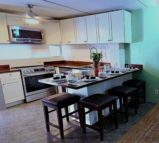 a kitchen with a stove a microwave and cabinets