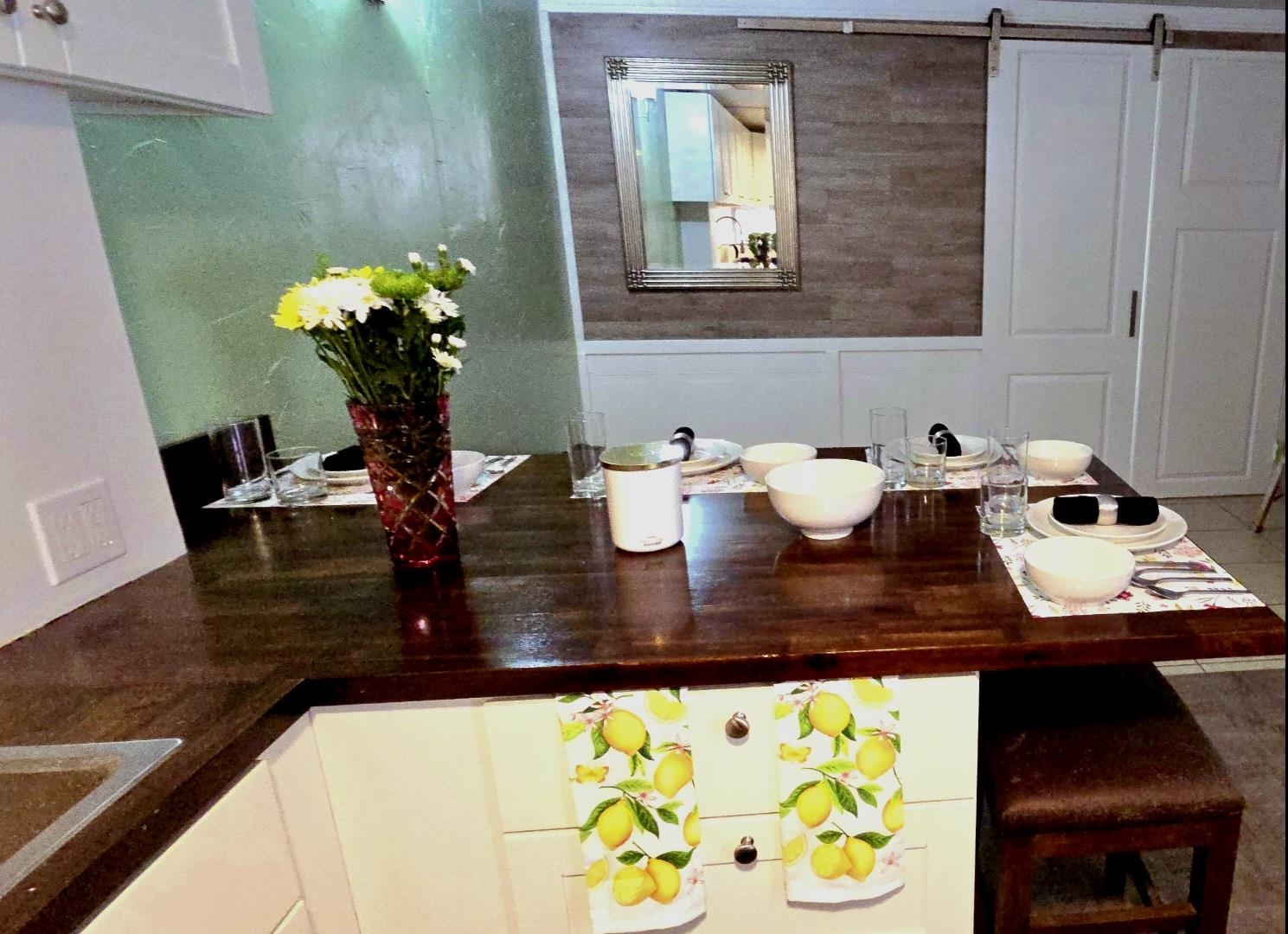 3676 Lower Honoapiilani Road, Unit F102 Lahaina, HI 96761 - Photo 7 of 12 a dining table with wooden floor