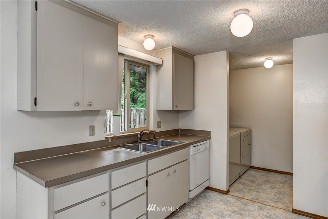 6742 North Enterprise Road Ferndale, WA 98248 - Photo 14 of 25 a kitchen with sink cabinets and window