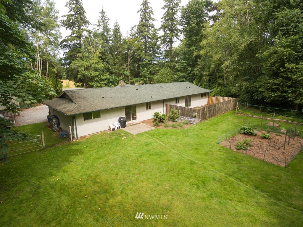 6742 North Enterprise Road Ferndale, WA 98248 - Photo 20 of 25 a aerial view of a house with swimming pool next to a big yard
