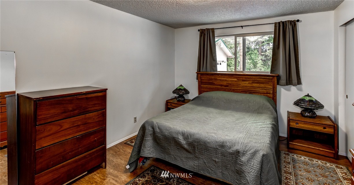 6742 North Enterprise Road Ferndale, WA 98248 - Photo 8 of 25 a bedroom with a bed and a window