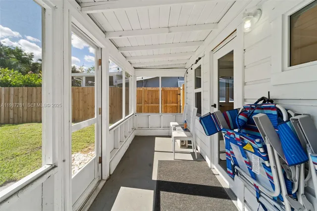 a view of an entryway with wooden floor and windows