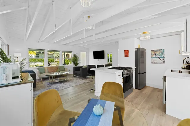 a living room with furniture a flat screen tv and a faucet