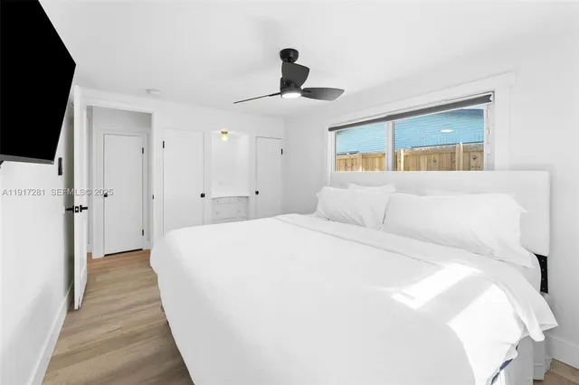 a spacious bedroom with a bed and a chandelier