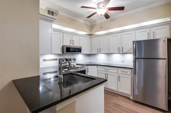 a kitchen with a sink and a stove top oven