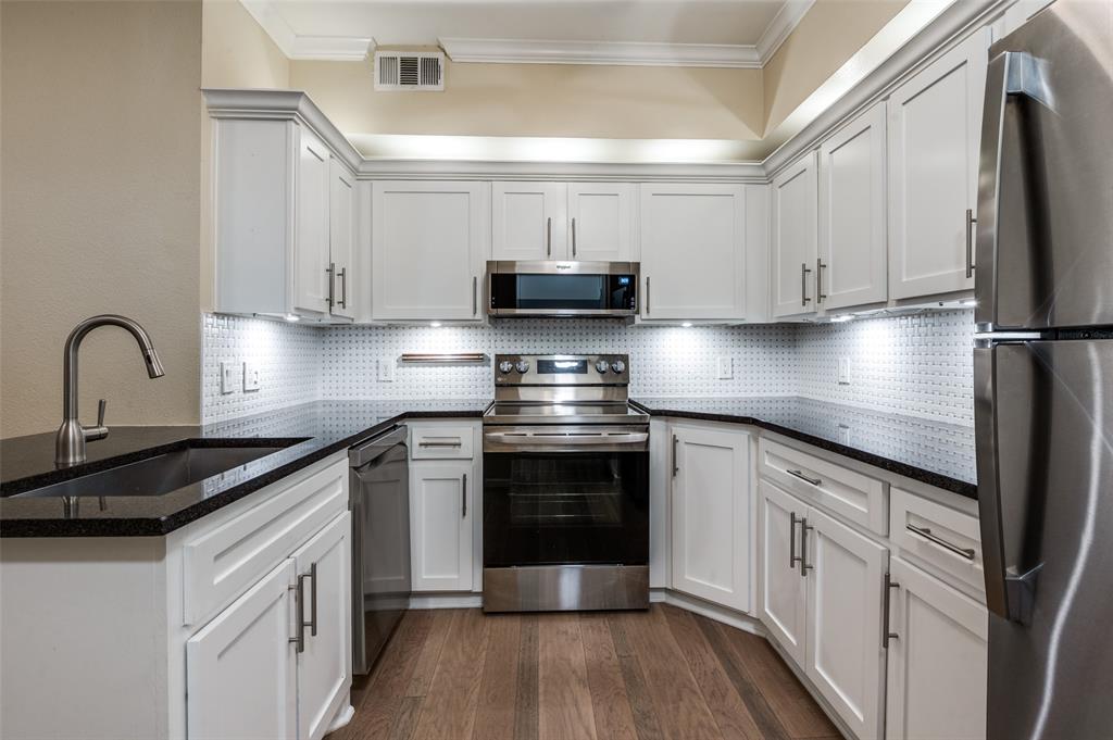 2601 Preston Road, Unit 3103 Plano, TX 75093 - Photo 14 of 30 a kitchen with a sink and a stove top oven