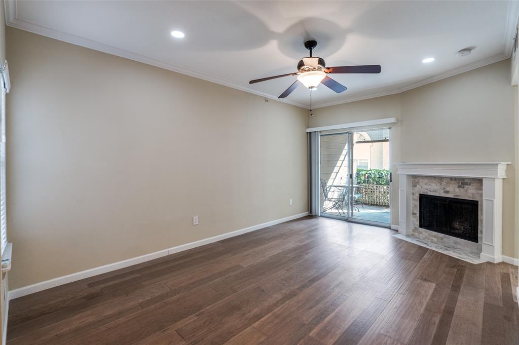 2601 Preston Road, Unit 3103 Plano, TX 75093 - Photo 7 of 30 a view of an empty room with wooden floor fireplace and a window