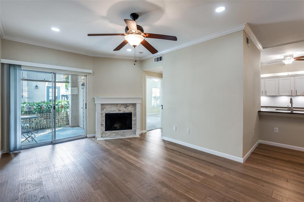 2601 Preston Road, Unit 3103 Plano, TX 75093 - Photo 8 of 30 a view of an empty room with wooden floor fireplace and a window