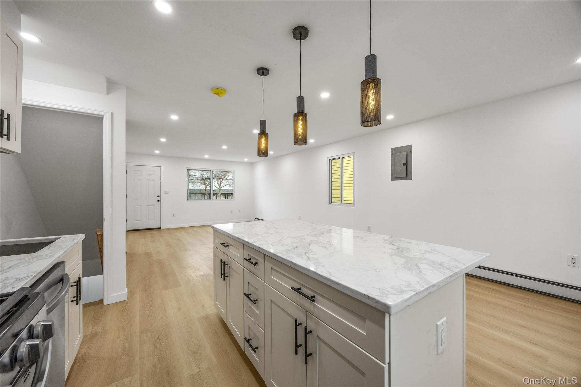 641 Beach 65th Street Queens, NY 11692 - Photo 12 of 34 a kitchen with a stove a sink a center island and wooden floor