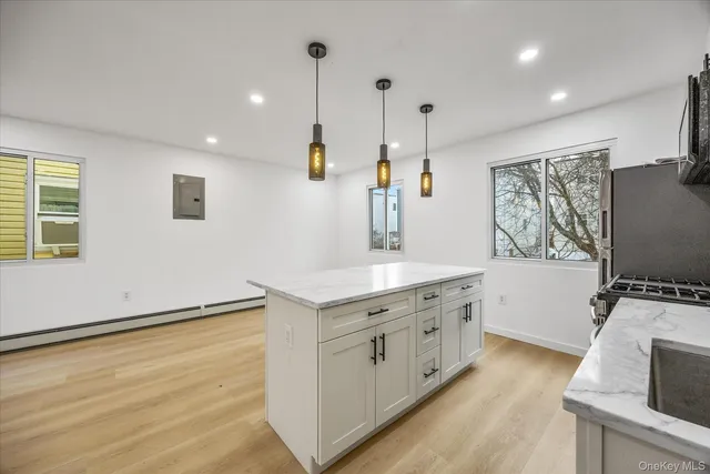 a kitchen with sink cabinets and wooden floor